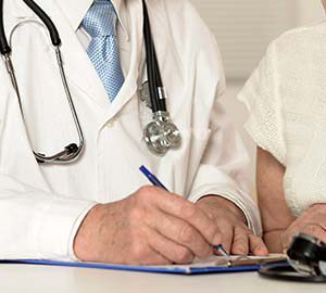 Elderly doctor with a patient on a white background