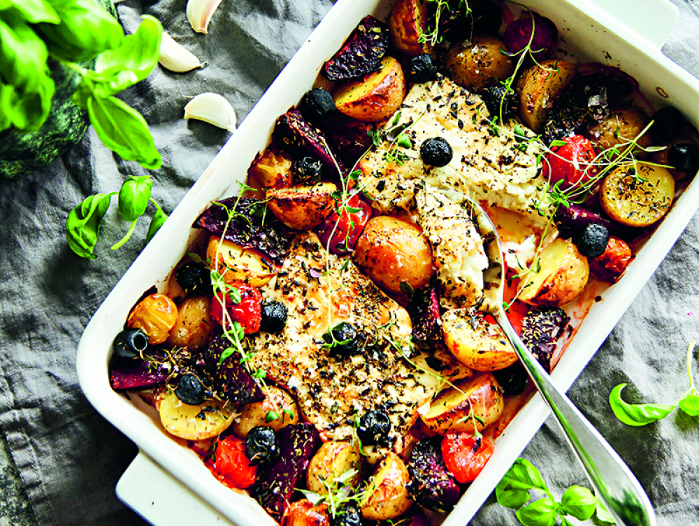 Oven baked feta cheese with root vegetables and garlic yogurt